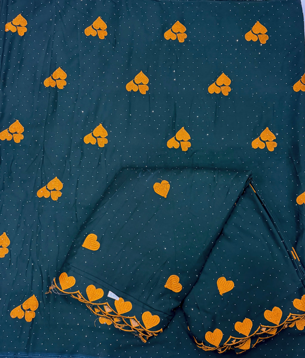 Dark blue fabric with yellow heart patterns and a folded section.