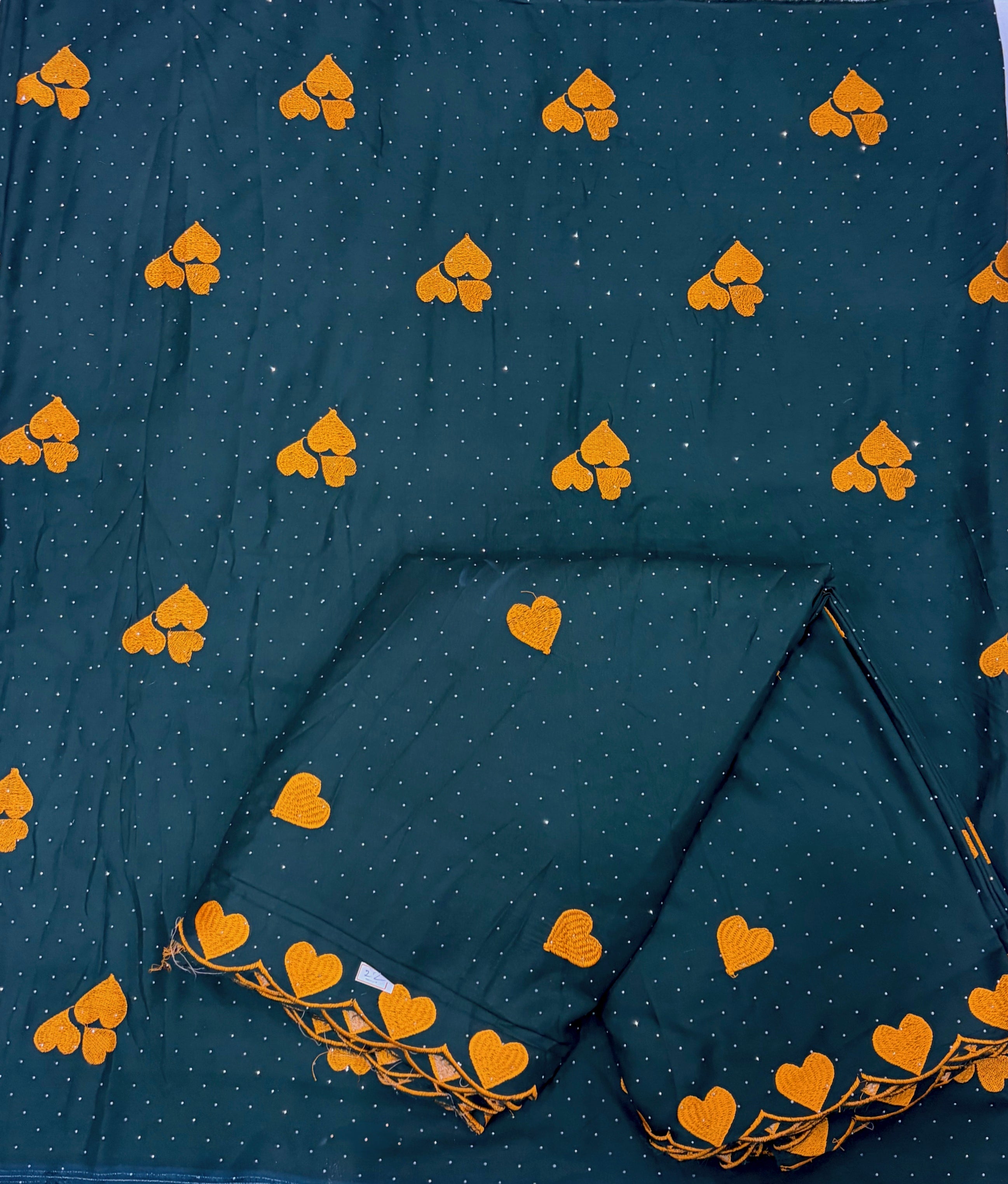 Dark blue fabric with yellow heart patterns and a folded section.