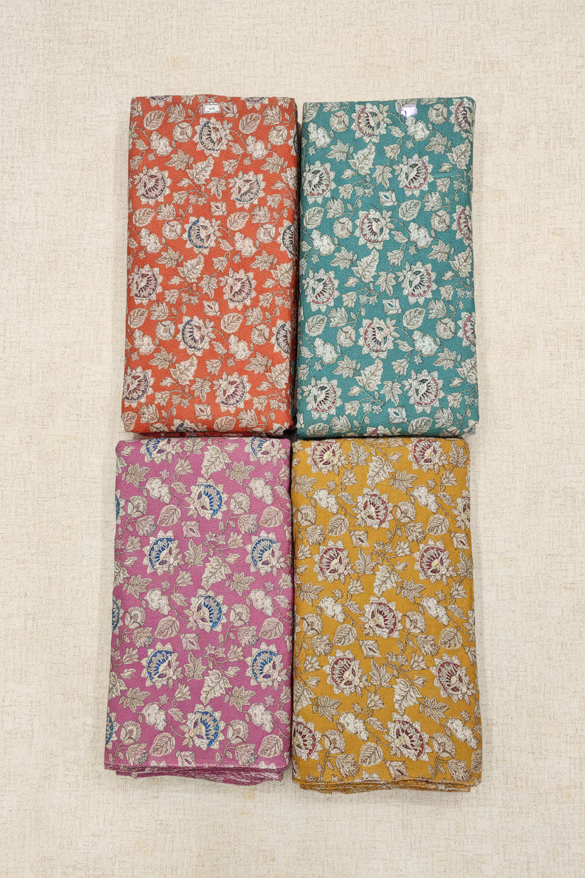 Four floral-patterned cloths in different colors on a tiled floor.