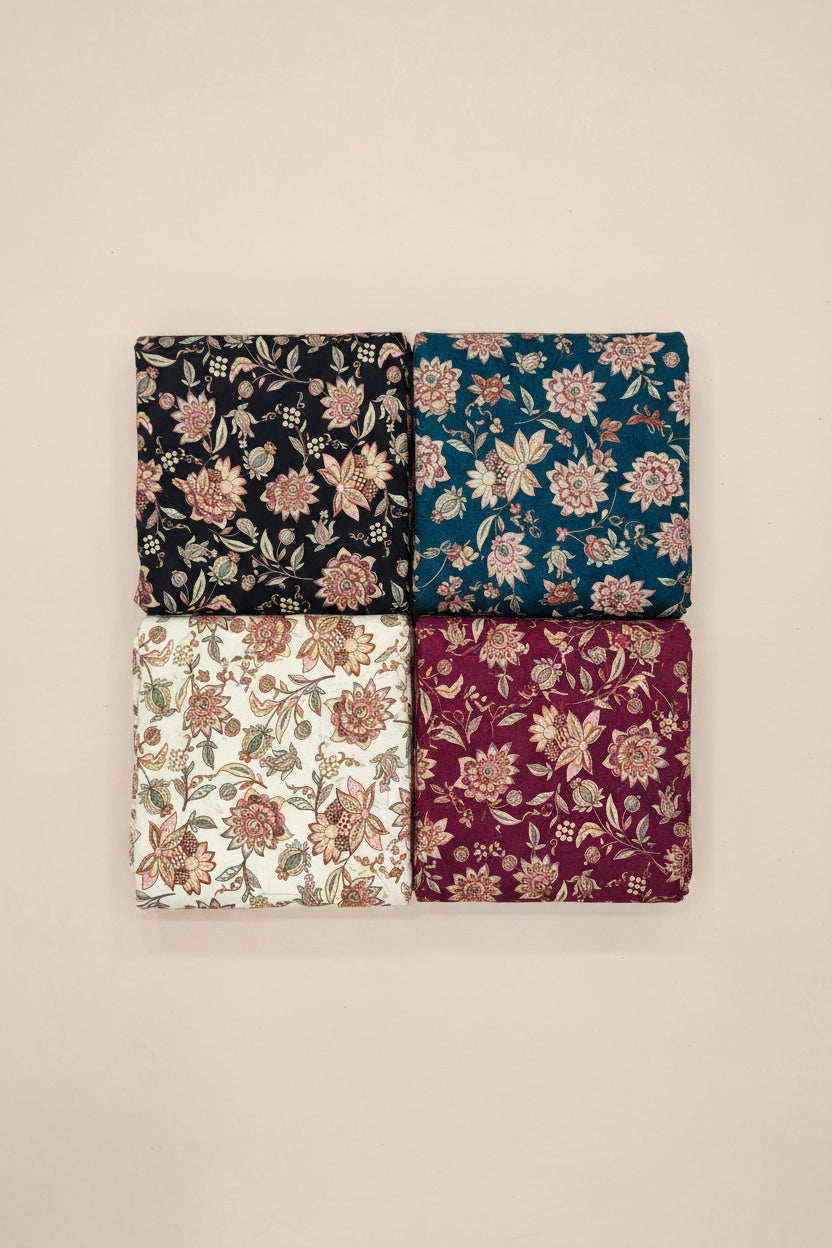 Floral patterned fabric swatches arranged on a tiled floor.